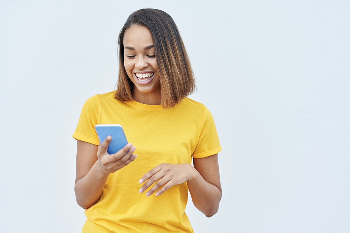 Woman laughing at her phone screen