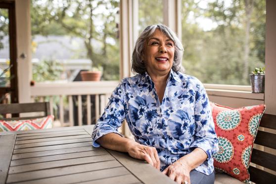 Senior smiling woman sitting on porch